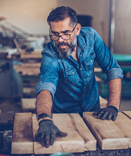 middle aged man woodworking with eye glasses